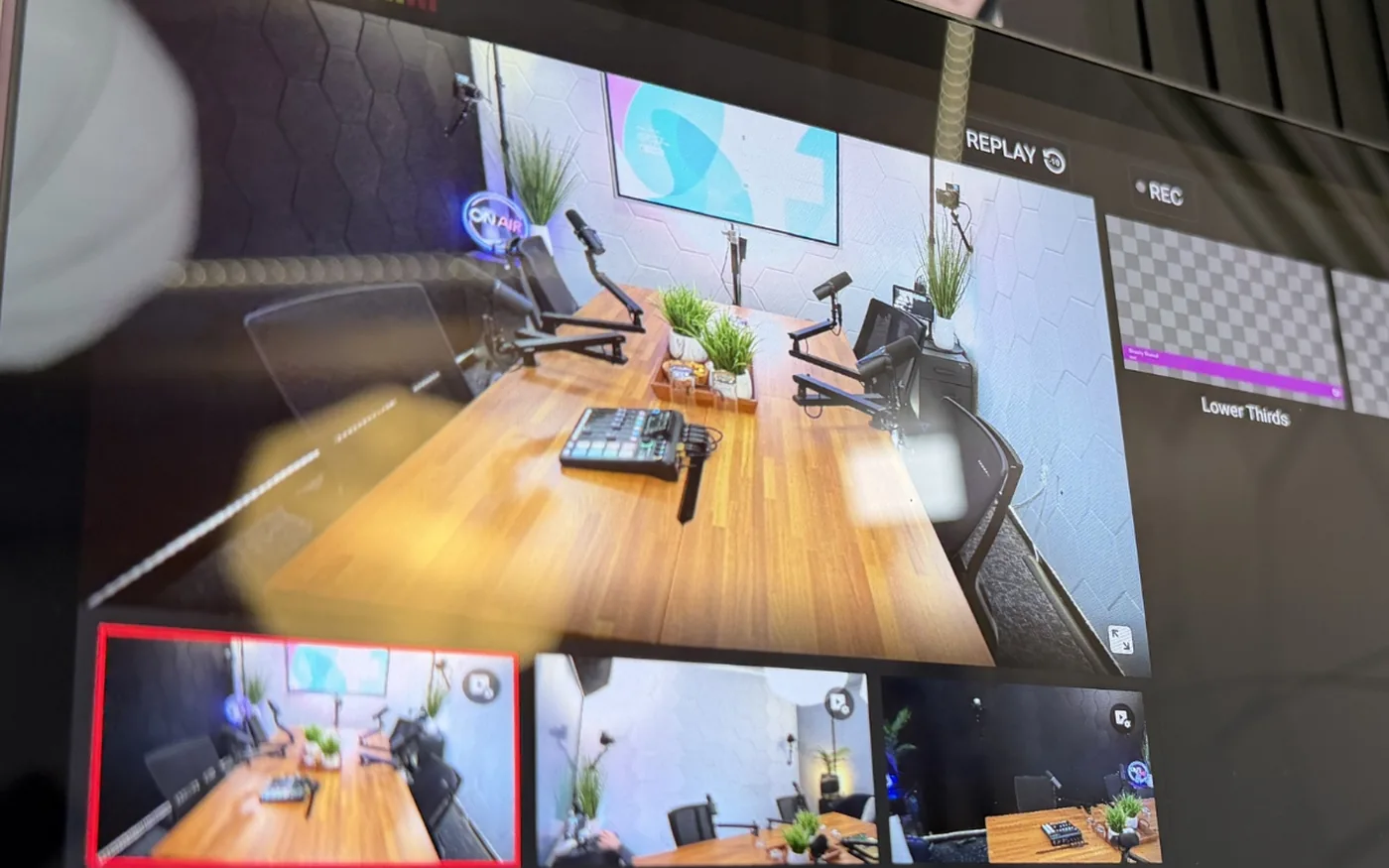 The multicam switcher at SA Cowork in San Antonio showing five live camera angles of the four-person podcast studio, with recording and lower-third controls